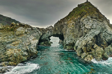 Fototapeta na wymiar A natural arched rock in the ocean