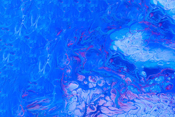 Colorful abstract background with mixed acrylic paints. Hand painted in the style of Fluid art. Trendy color 2020.