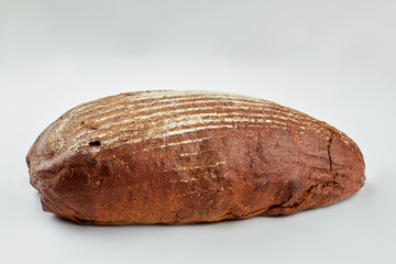 Loaf of bread and copy space. Fresh rye bread isolated on white background.