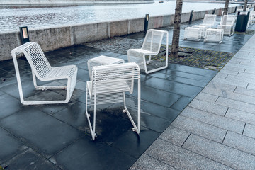 Outdoor furniture made of painted metal on the river embankment. Vandal-proof furniture. Urban...