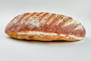 Crispy bread with flour on white background. Delicious artisan bread. Healthy food concept.