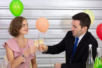 A couple celebrate happy new year and christmas day party with wine clink glasses in dinning room