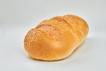 French bread with sesame seeds. Loaf of fresh bread isolated on white background.