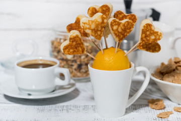 conceptual mini sweet pancakes in the form of hearts for breakfast