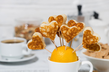 conceptual mini sweet pancakes in the form of hearts for breakfast, closeup
