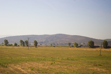 Beautiful view on yellow hills and grassland with green trees, stone rocks in Bodrum, Mugla, Turkey. Travel and vacation concept