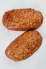 Natural whole grain bread on white background. Whole wheat bread with pumpkin seeds, top view.