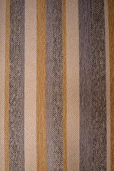 Multicolor stripes on a rough furniture fabric. Creative vintage background.