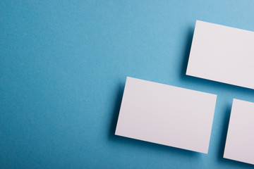 Business card blank on wooden background. Corporate Stationery, Branding Mock-up. Creative designer desk. Flat lay. Copy space for text