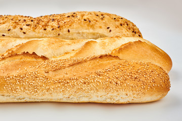 Close up of crusty baguettes with sesame seeds. Freshly baked long bread. Delicious homemade food.