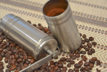 Vintage manual coffee grinder with roasted coffee beans