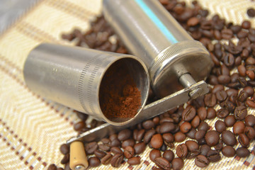 Vintage manual coffee grinder with roasted coffee beans