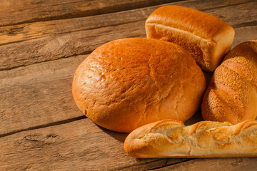 Bread and bakery products on wooden background. Organic famers bread. Rustic still life.