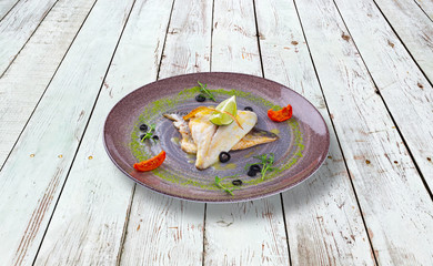 Dorada and over sea wolf, grilled with vegetables and sauce.