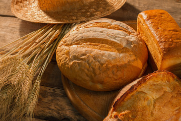 Bread and wheat ears. Fresh homemade bread with golden crust. Bakery concept.