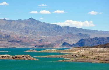 Fototapeta na wymiar Lake Mead with green water and layered rocks National Recreation Area near Las Vegas, Nevada