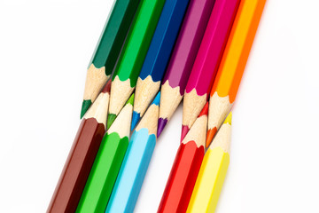 Wooden colored pencils of different colors on a white background
