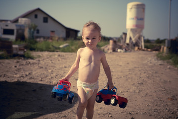 little boy playing on the construction site