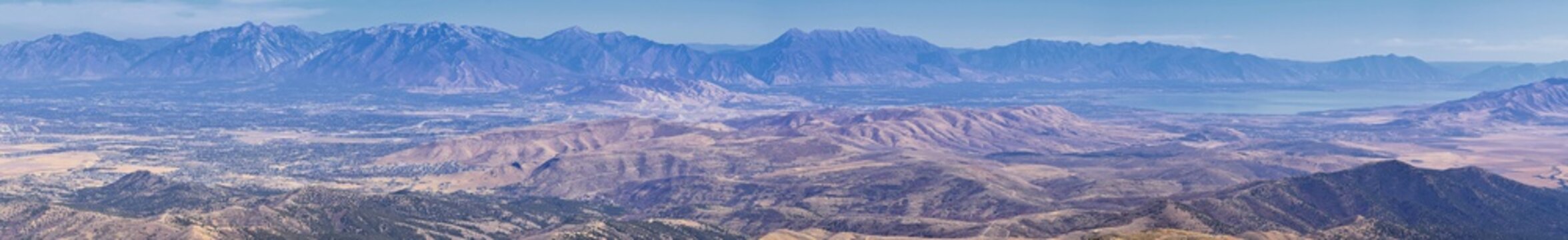 Wasatch Front Rocky Mountain landscapes from Oquirrh range looking at Utah Lake during fall. Panorama views near Provo, Timpanogos, Lone and Twin Peaks. Salt Lake City. United States.