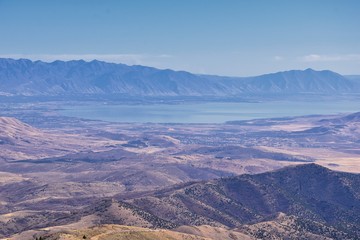 Wasatch Front Rocky Mountain landscapes from Oquirrh range looking at Utah Lake during fall. Panorama views near Provo, Timpanogos, Lone and Twin Peaks. Salt Lake City. United States.