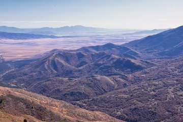 Wasatch Front Rocky Mountain landscapes from Oquirrh range looking at Utah Lake during fall. Panorama views near Provo, Timpanogos, Lone and Twin Peaks. Salt Lake City. United States.