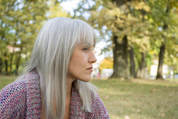 Outdoors portrait of a woman. Profile view. Silver hair.