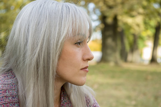 Outdoors Portrait Of A Woman. Profile View. Silver Hair.