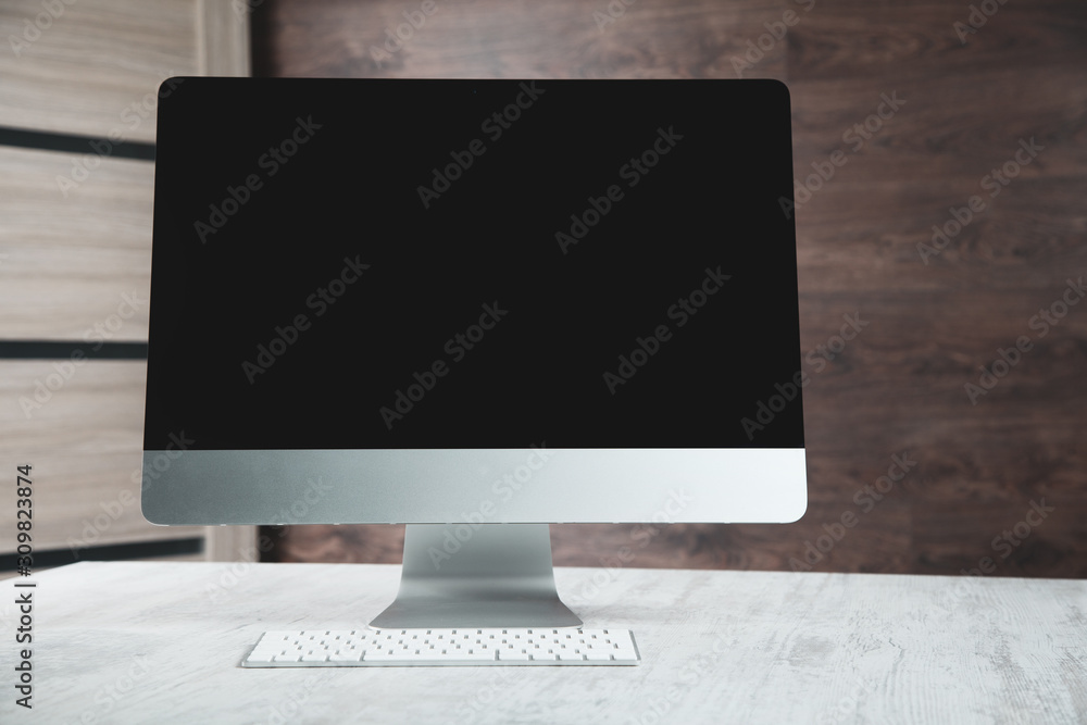 Aufkleber computer with keyboard on the desk on brown background