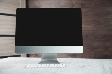 computer with keyboard on the desk on brown background