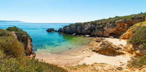 Sand and pebbles in a small cove in Alghero shore