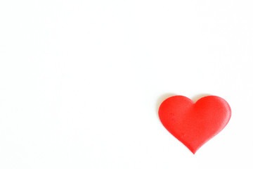 Fototapeta premium Red silk heart on a white background. Minimalistic concept for a Valentine's Day greeting card, for medical publications or for a life insurance theme