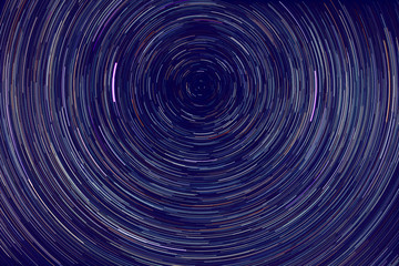 star trails -  light streaks of stars around Polaris in the night sky due to Earth's rotation