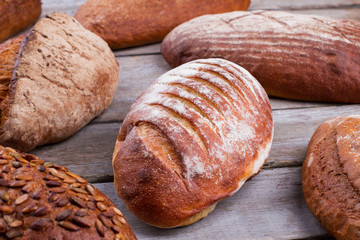 Fresh crusty bread on wooden background. Delicious freshly baked bread.