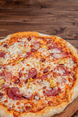 Pizza with Mozzarella cheese, salami, Tomatoes, pepper, Spices. Italian pizza