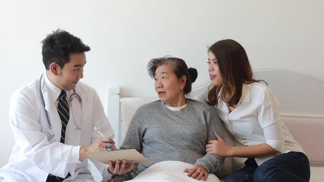 Asian senior woman in hospital with doctor