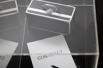 Contract and case for money lies in transparent box