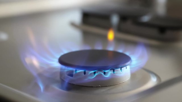 HD ProRes slow motion clip of a propane gas burner on a stove-top appliance igniting
