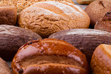 Farmers homemade bread close up. Assortment of crusty wholemeal bread. Delicious homemade product.