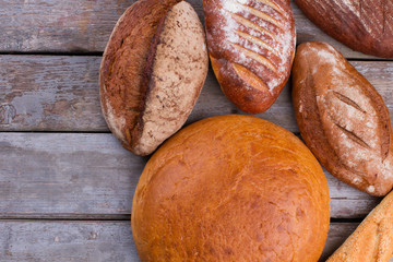 Rustic sourdough bread on wooden background. Freshly baked healthy bread background. Natural food store.