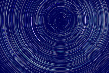 star trails -  light streaks of stars around Polaris in the night sky due to Earth's rotation