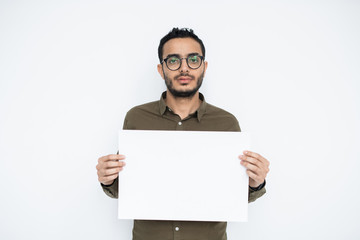 Young businessman with blank face holding empty poster for advertisement