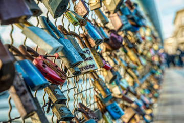 Naklejka premium Love and fidelity. Padlocks on a suspension pedestrian bridge in Krakow, Poland