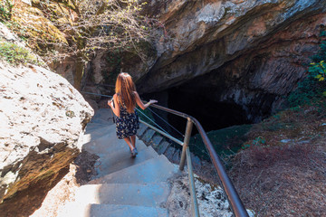 Girl tourist go into Dikteo Andro Cave also known as birth place of Zeus