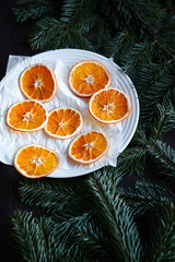 Obraz na płótnie Canvas the drying process of sliced oranges on a white plate