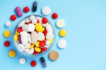 A bowl with colorful medicine pills	