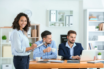 Young businesswoman with his partners in office