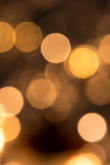 Christmas background of round sparkling lights in darkness