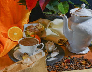biscuits on the table between plants and coffee with milk and chocolate