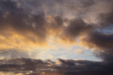 Fototapeta na wymiar Beautiful sky at sunset. Sunlight illuminates clouds, dark clouds.