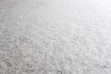 White snow background for designers. White snow closeup snowflakes, perspective. Snow crystals on the earth.